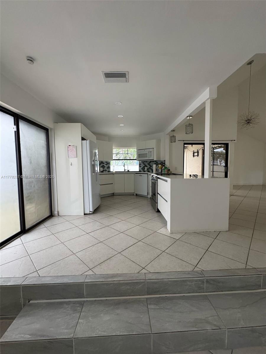 17320 Northwest 62nd Place Hialeah, FL 33015 - Photo 19 of 27 a view of a refrigerator and window in a room