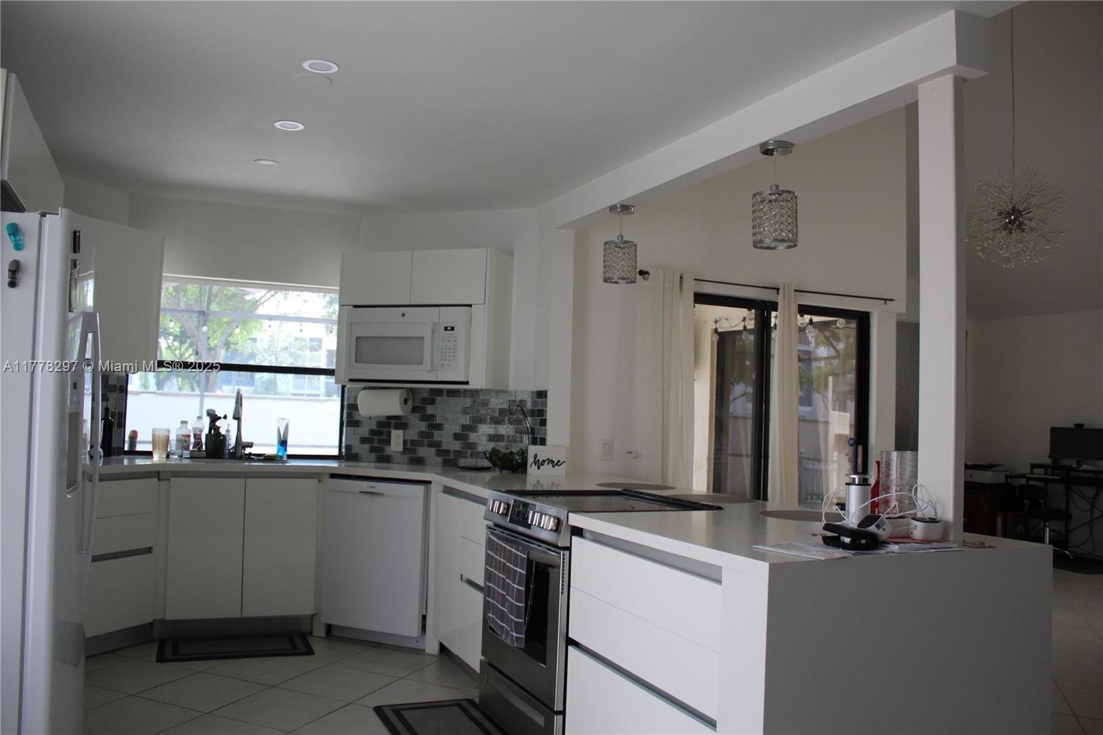 17320 Northwest 62nd Place Hialeah, FL 33015 - Photo 3 of 27 a kitchen with stainless steel appliances a sink stove and cabinets