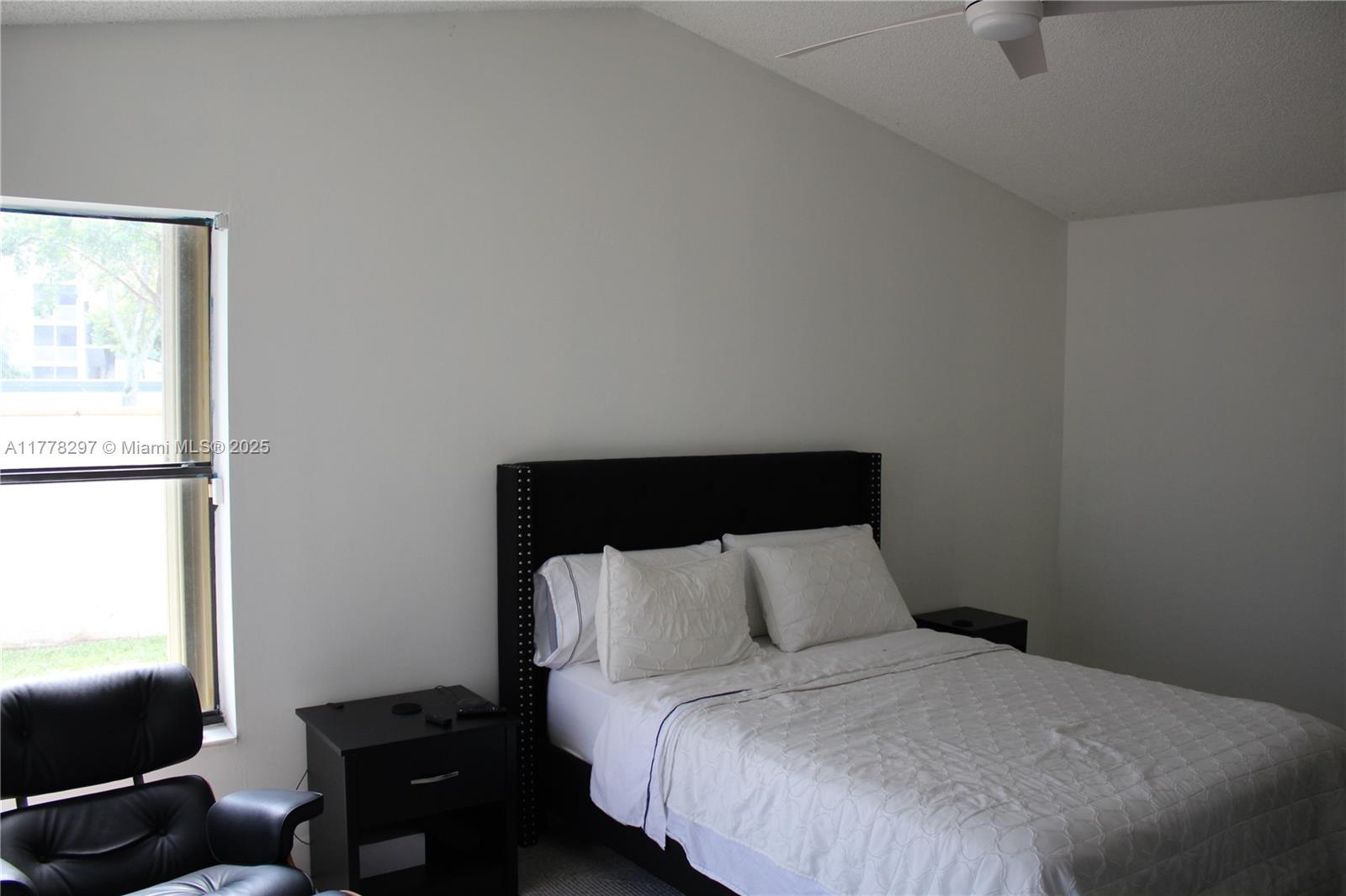17320 Northwest 62nd Place Hialeah, FL 33015 - Photo 5 of 27 a bedroom with a bed and a flat screen tv