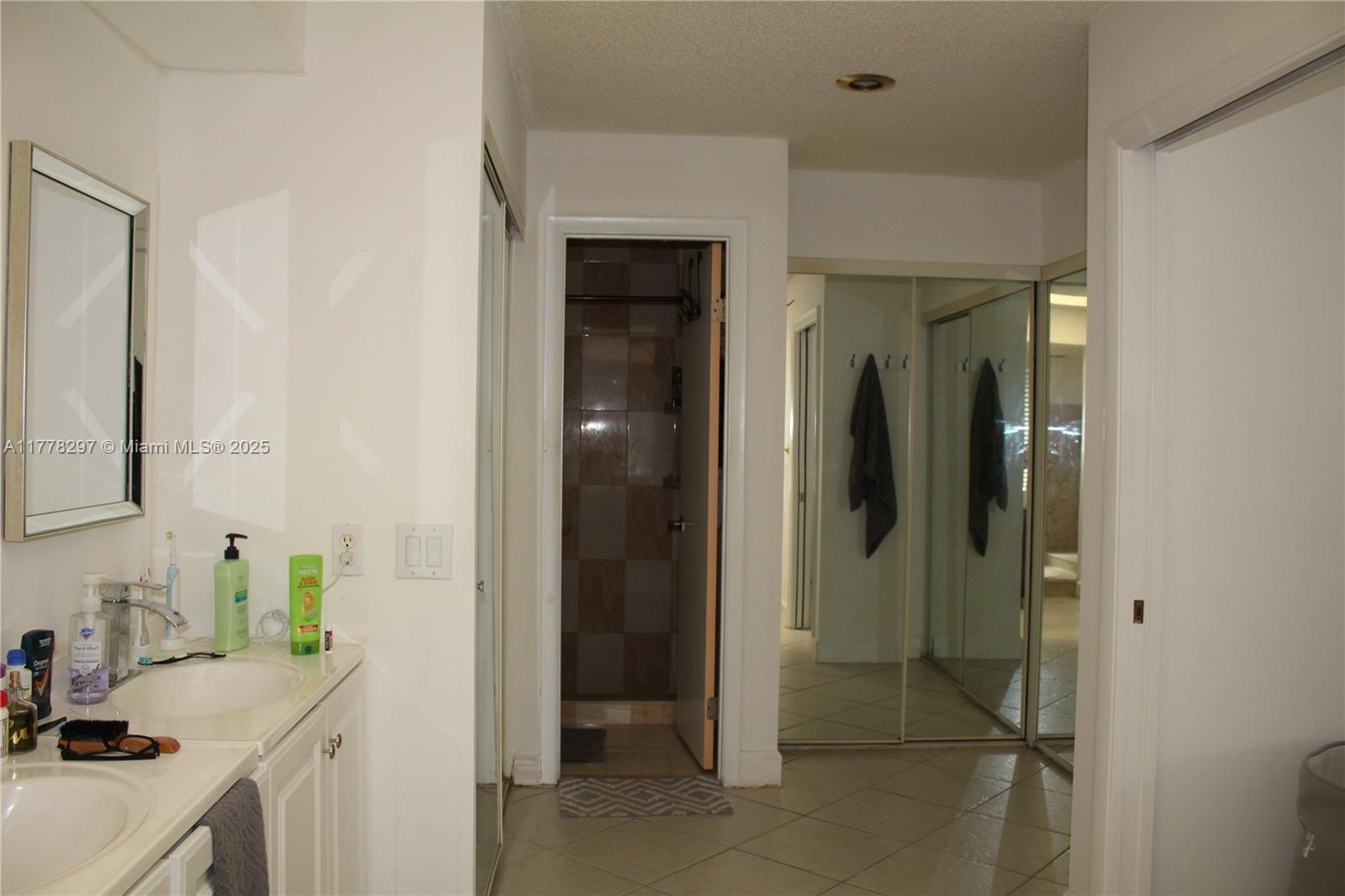 17320 Northwest 62nd Place Hialeah, FL 33015 - Photo 8 of 27 a room that has a sink and a mirror in it