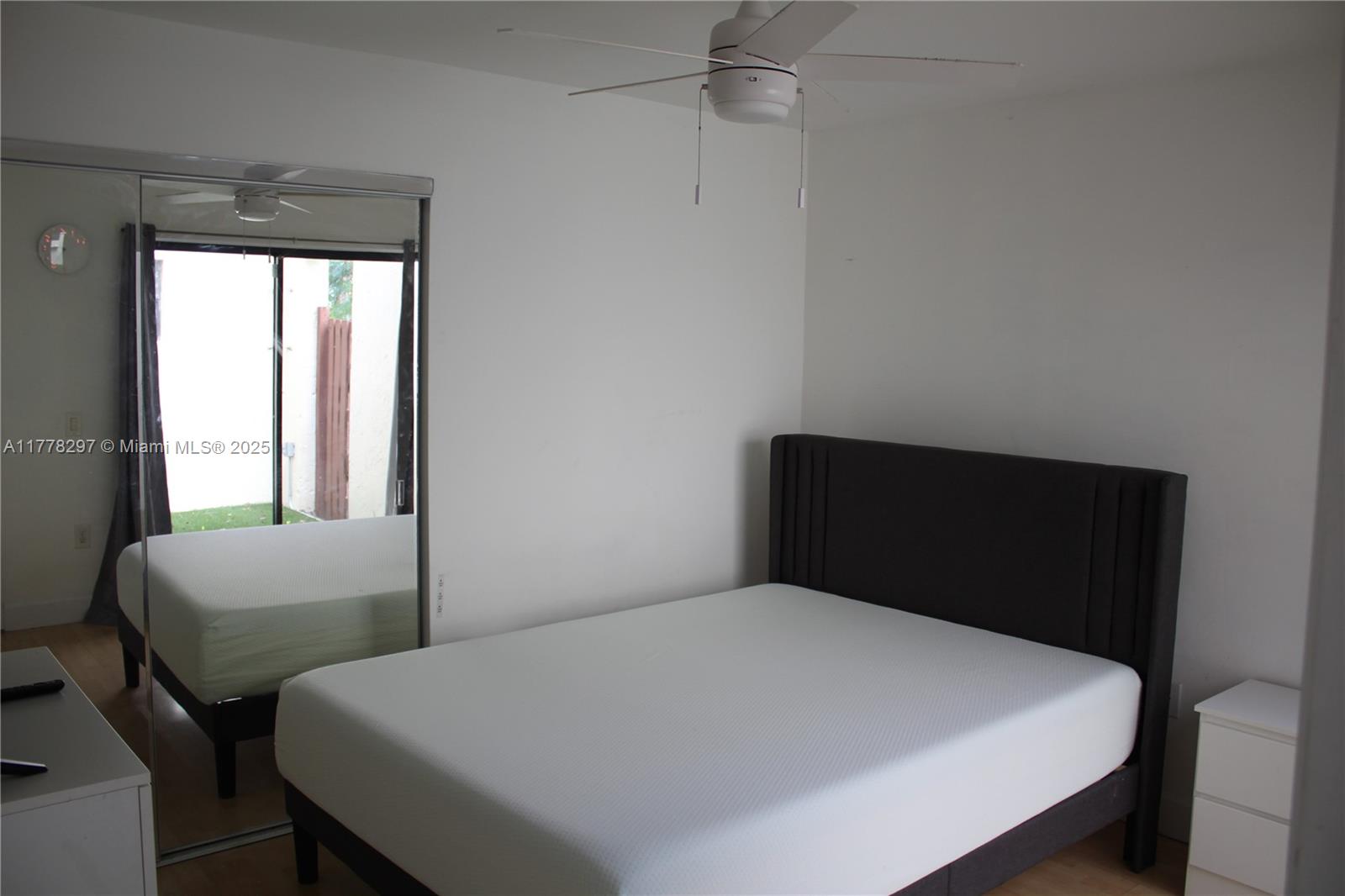 17320 Northwest 62nd Place Hialeah, FL 33015 - Photo 9 of 27 a bedroom with a bed two windows and with chair