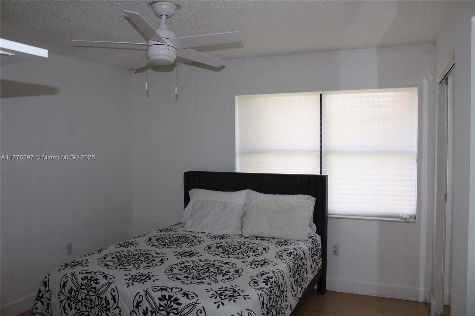 17320 Northwest 62nd Place Hialeah, FL 33015 - Photo 10 of 27 a bedroom with a bed and a window
