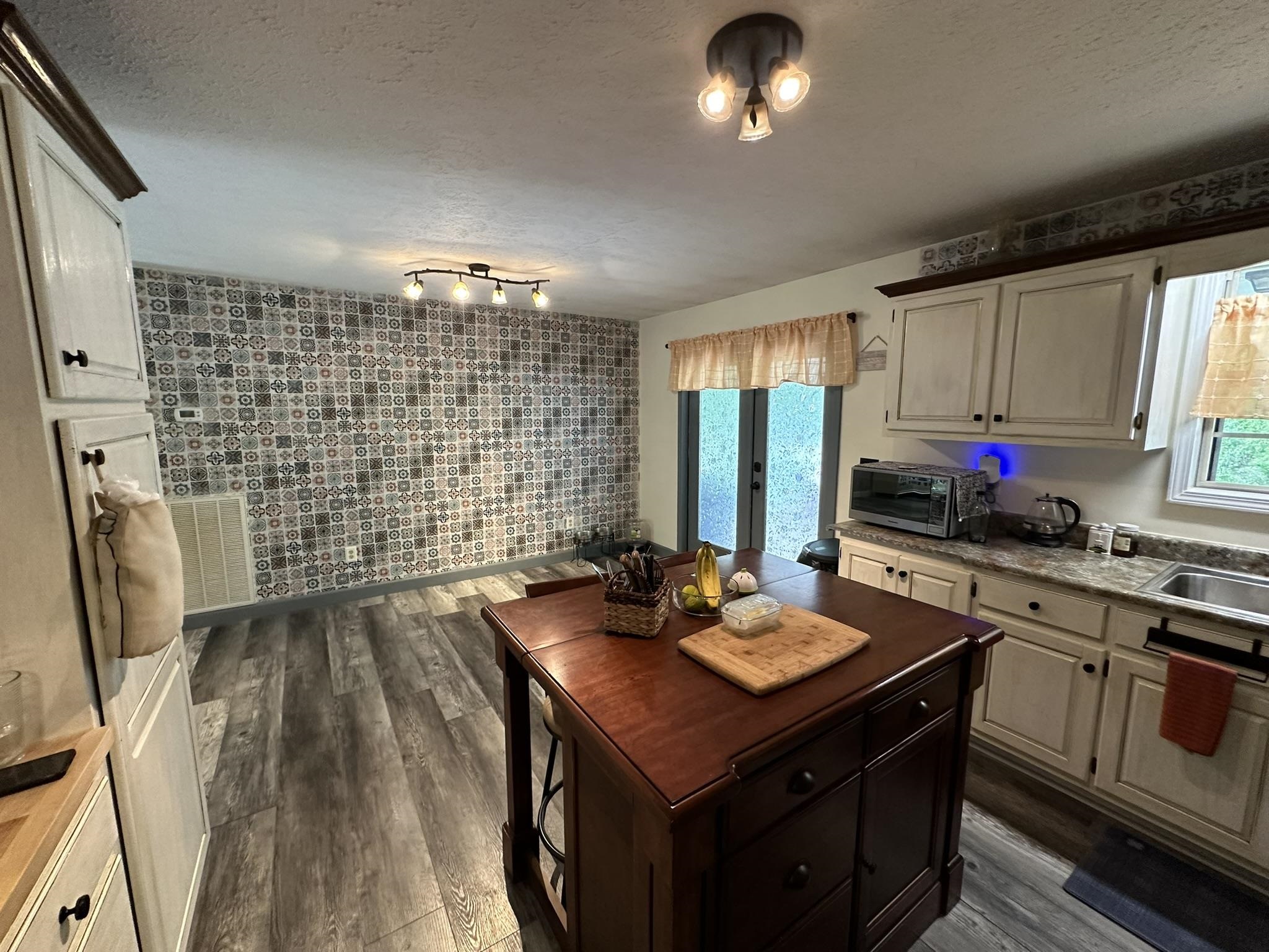 576 Carroll Hollow Road Waynesboro, TN 38485 - Photo 12 of 40 a kitchen with sink cabinets and stove
