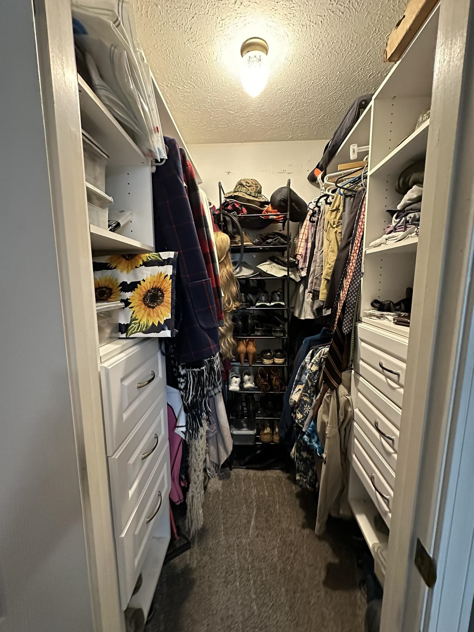 576 Carroll Hollow Road Waynesboro, TN 38485 - Photo 19 of 40 a view of walk in closet with clothes and shoes