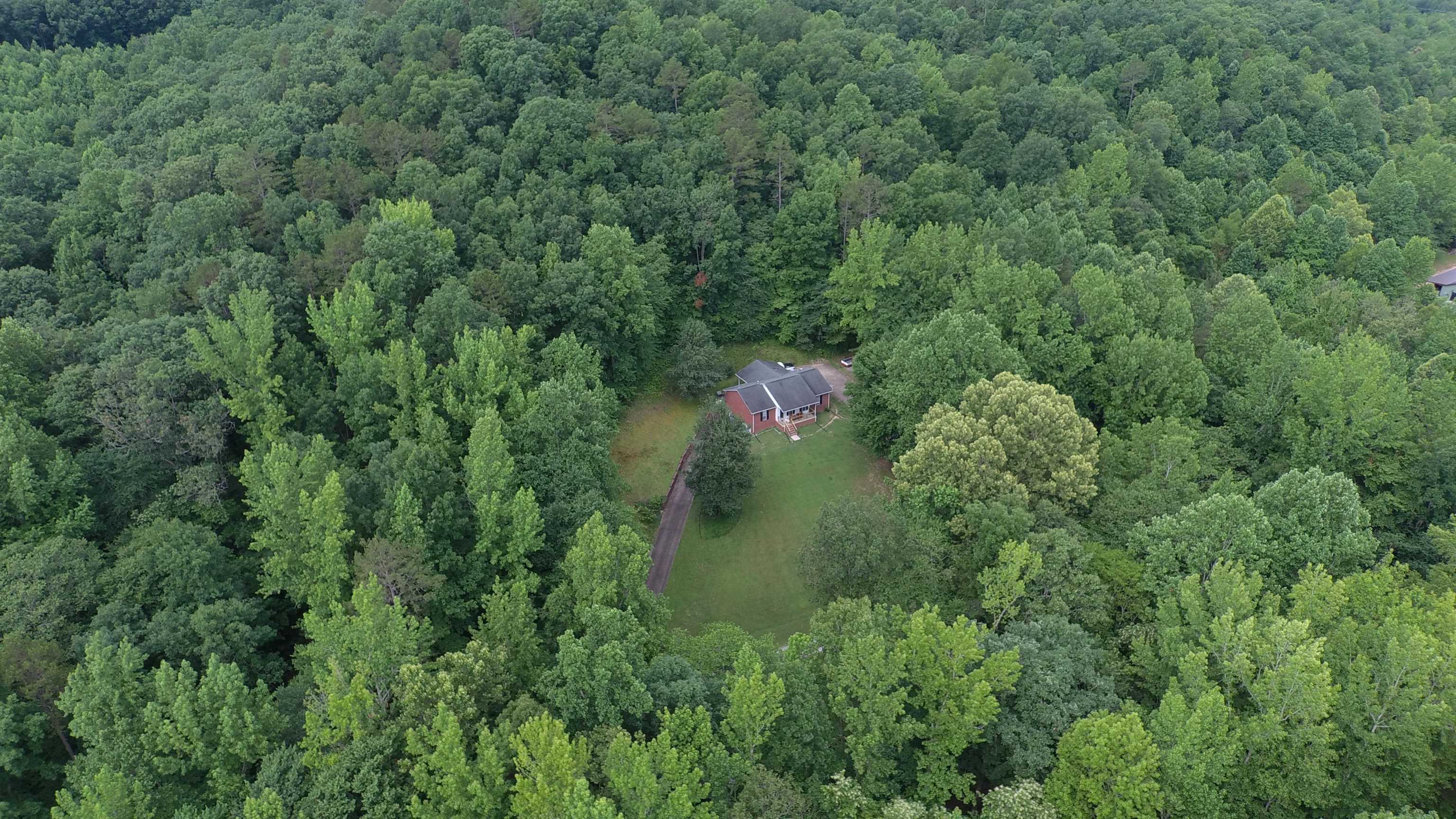 576 Carroll Hollow Road Waynesboro, TN 38485 - Photo 3 of 40 an aerial view of a house with a lush green forest