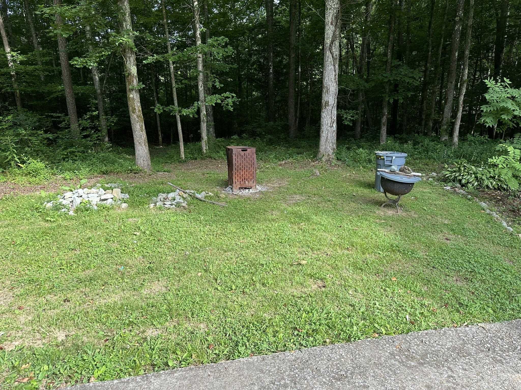 576 Carroll Hollow Road Waynesboro, TN 38485 - Photo 37 of 40 a view of a chair in a backyard with wooden fence