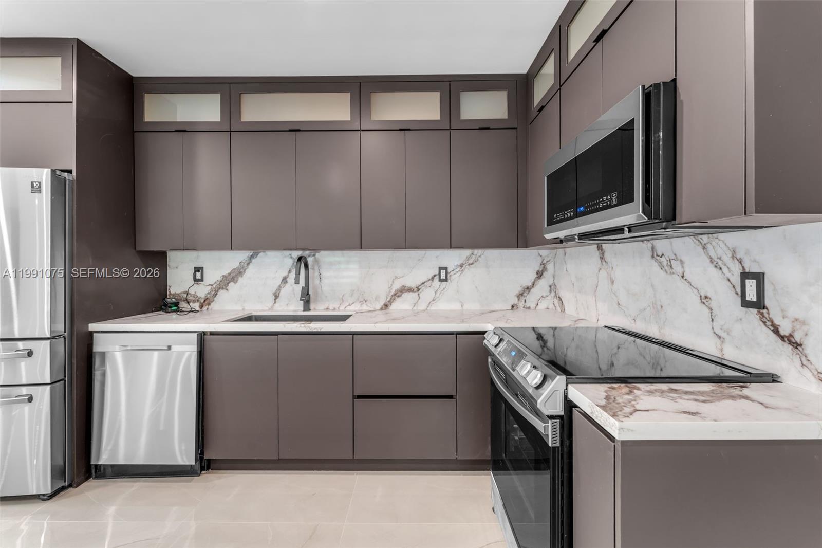 7920 Southwest 132nd Street Pinecrest, FL 33156 - Photo 12 of 45 a utility room with stainless steel appliances granite countertop a sink and a microwave
