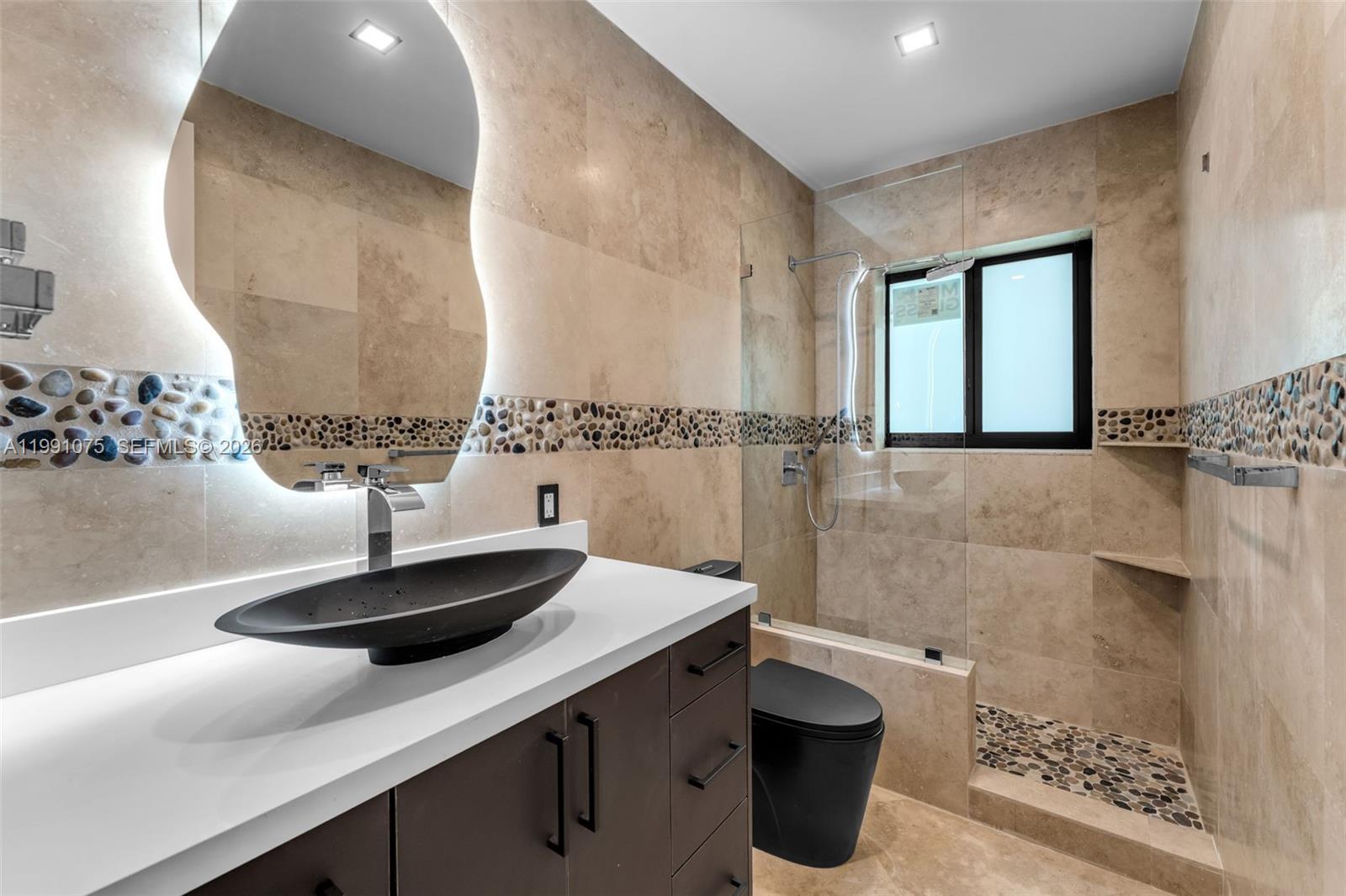 7920 Southwest 132nd Street Pinecrest, FL 33156 - Photo 14 of 45 a bathroom with a sink and a mirror