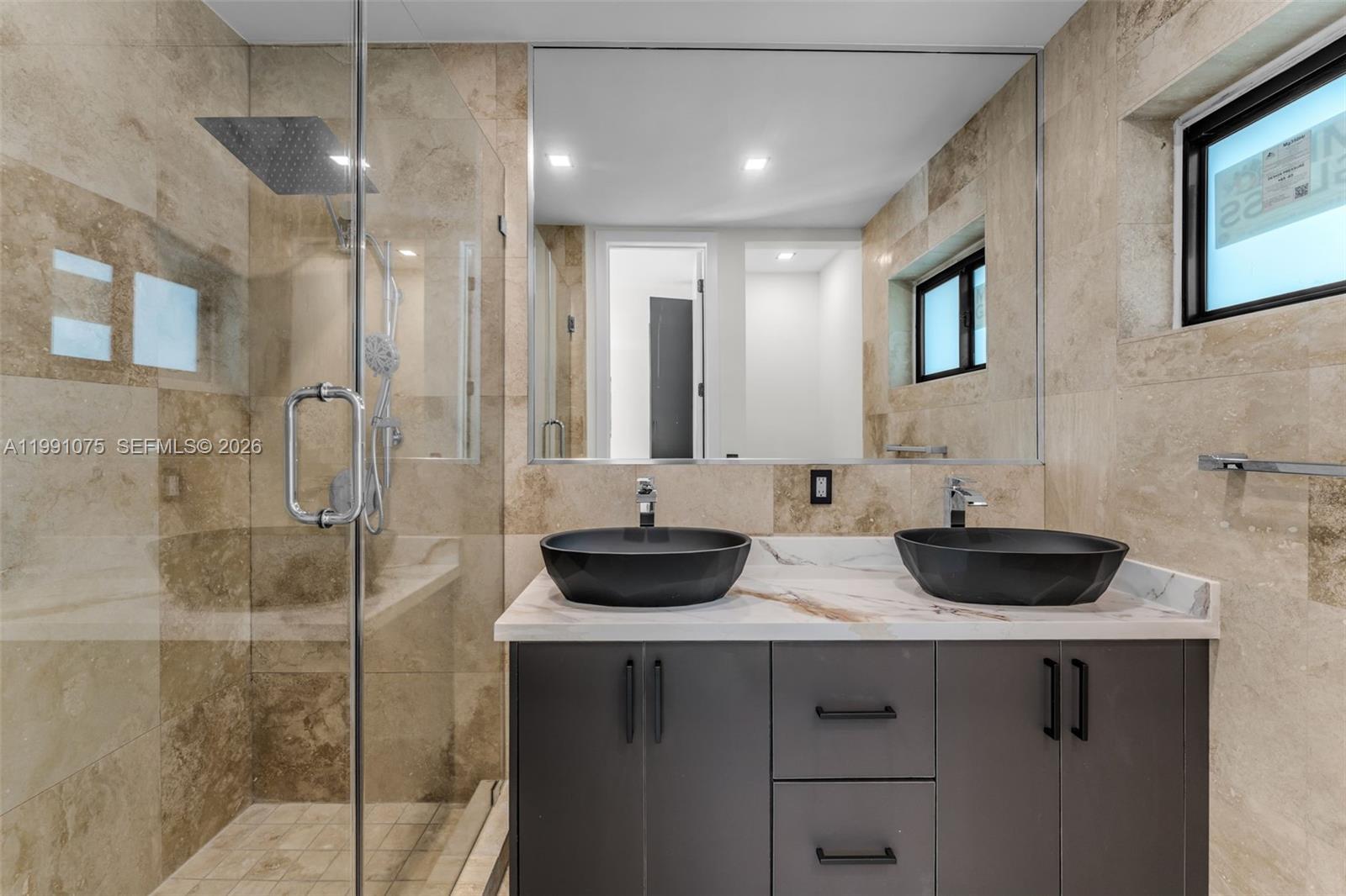 7920 Southwest 132nd Street Pinecrest, FL 33156 - Photo 25 of 45 a bathroom with a sink and a mirror