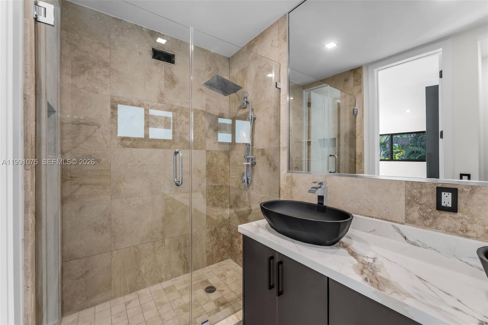 7920 Southwest 132nd Street Pinecrest, FL 33156 - Photo 26 of 45 a bathroom with a granite countertop sink a shower and a mirror