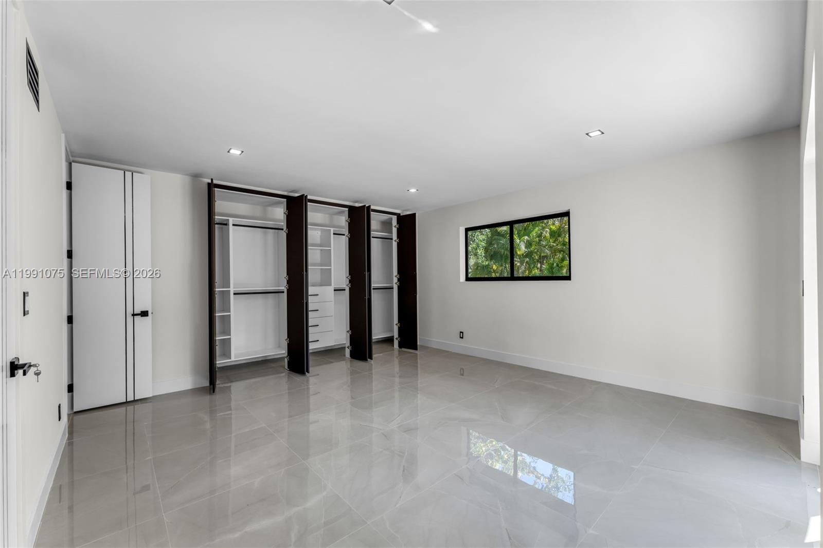 7920 Southwest 132nd Street Pinecrest, FL 33156 - Photo 27 of 45 an empty room with windows