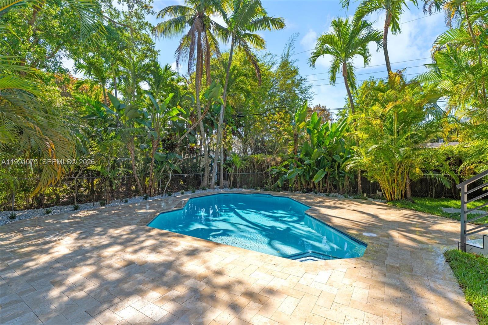 7920 Southwest 132nd Street Pinecrest, FL 33156 - Photo 31 of 45 a view of a backyard with large trees