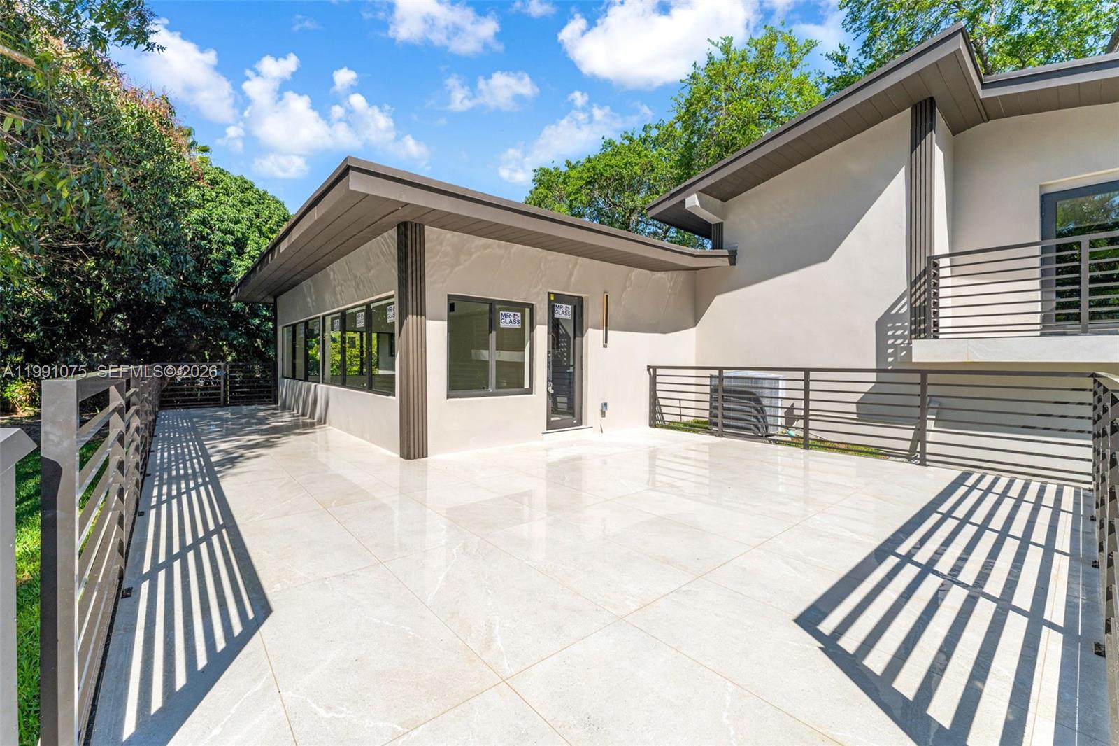 7920 Southwest 132nd Street Pinecrest, FL 33156 - Photo 35 of 45 a view of backyard with a deck and outdoor seating
