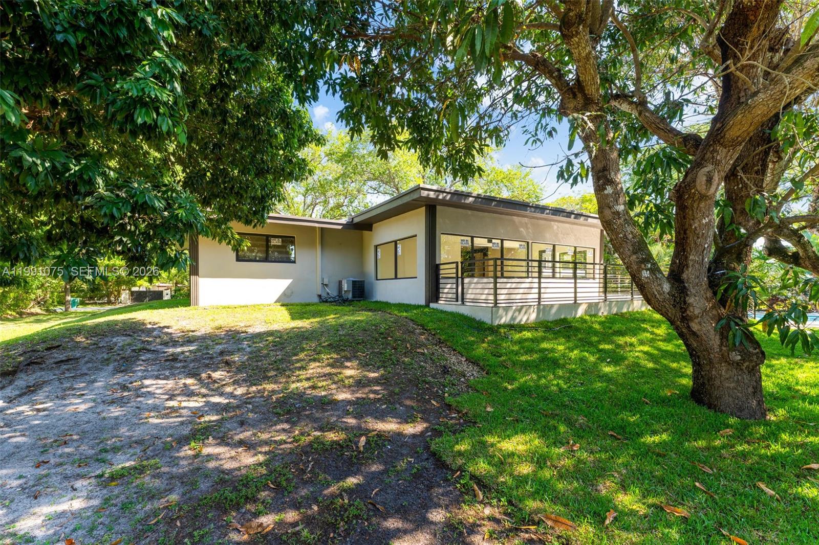 7920 Southwest 132nd Street Pinecrest, FL 33156 - Photo 39 of 45 a view of a house with yard and tree s