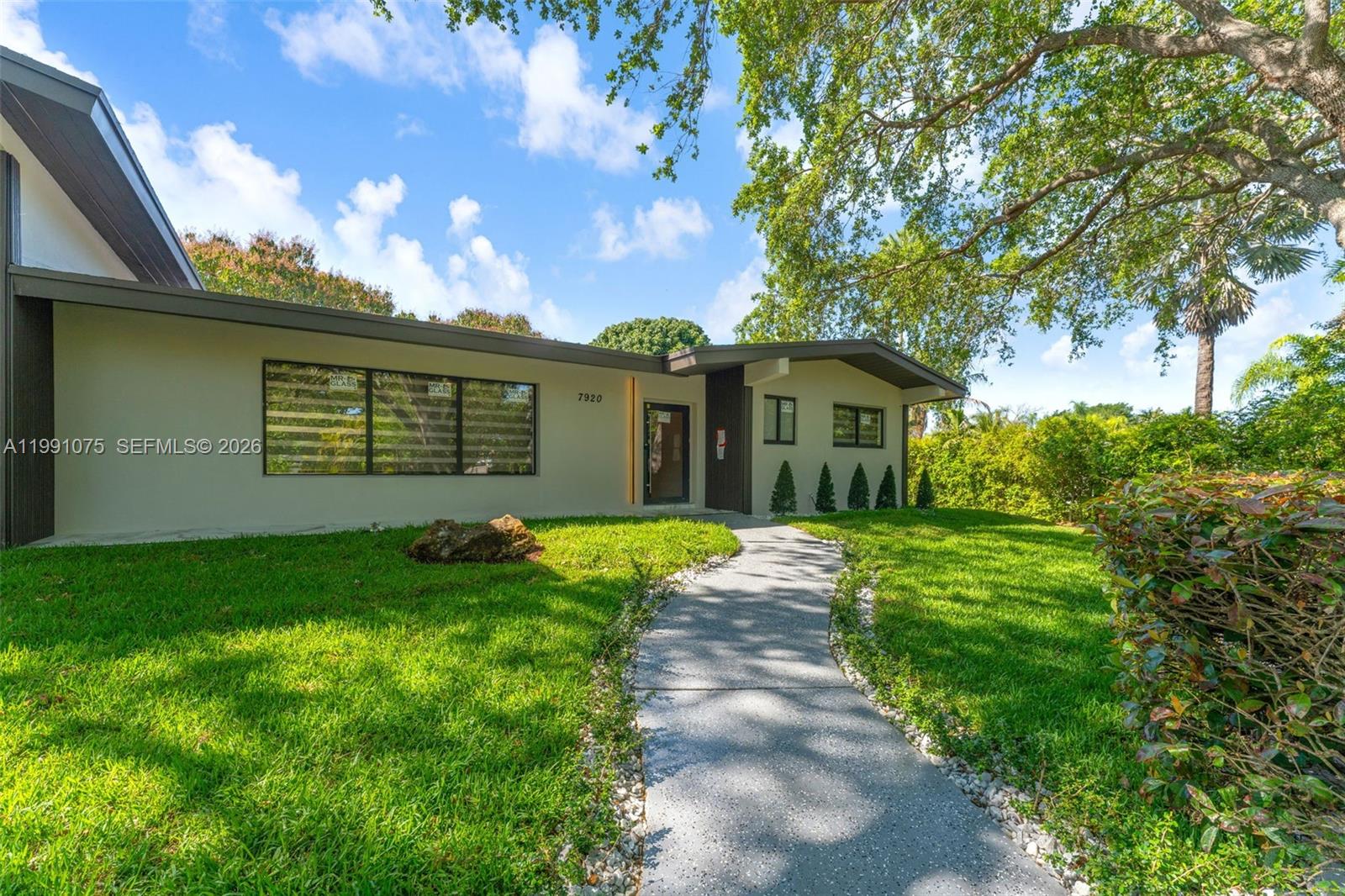 7920 Southwest 132nd Street Pinecrest, FL 33156 - Photo 4 of 45 a view of a house with a backyard