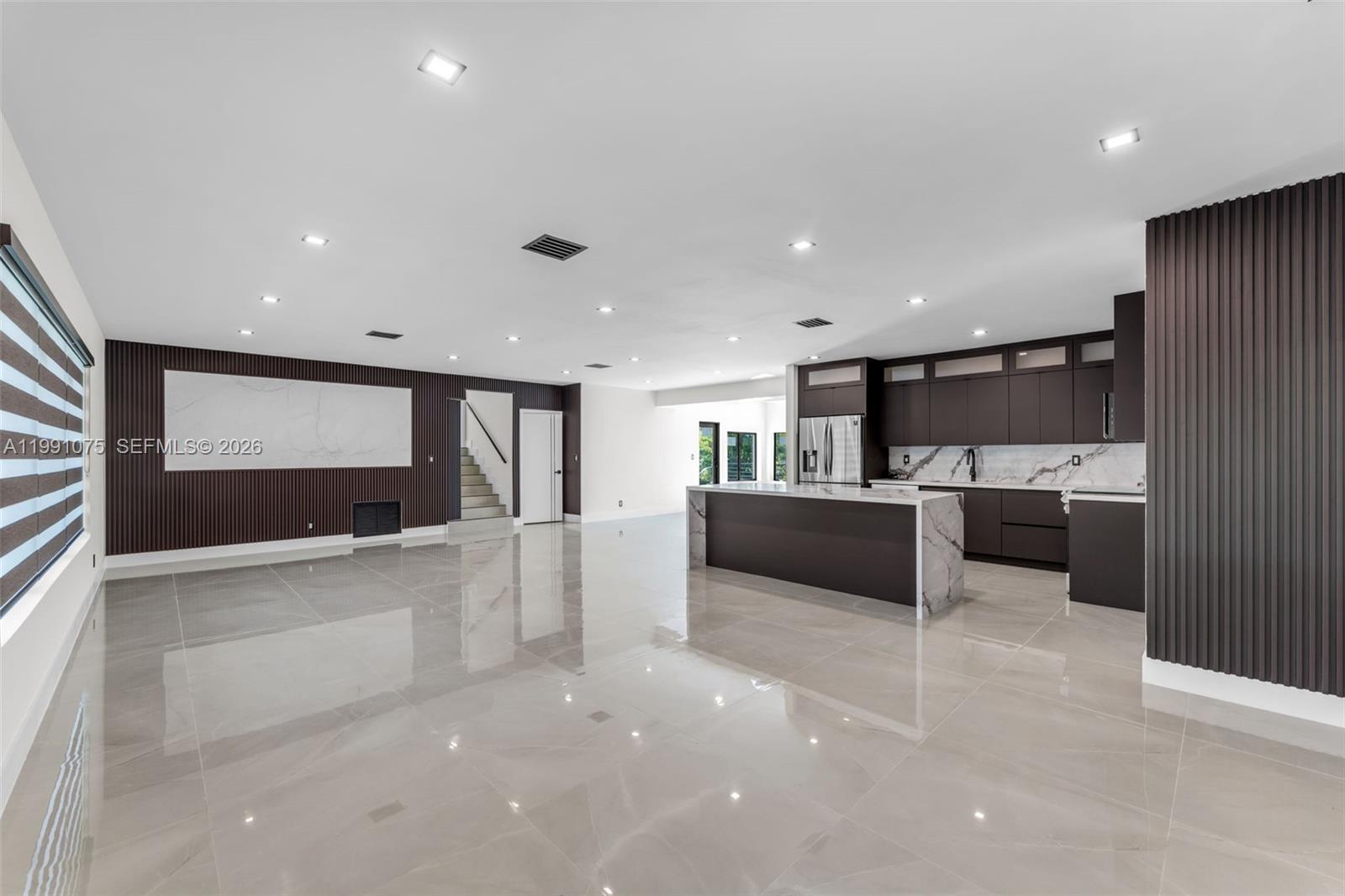 7920 Southwest 132nd Street Pinecrest, FL 33156 - Photo 5 of 45 a large white kitchen with a large counter top furniture and a kitchen view