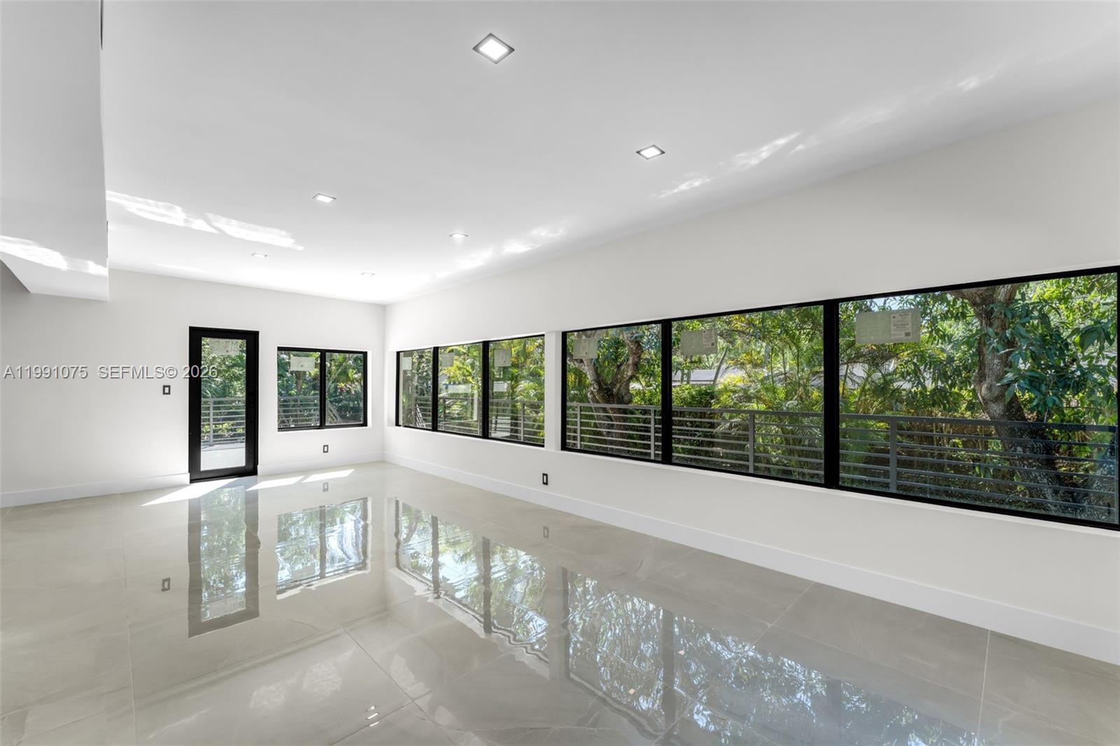 7920 Southwest 132nd Street Pinecrest, FL 33156 - Photo 8 of 45 a view of an empty room with a large window