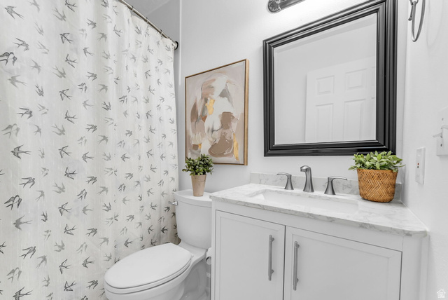 1147 West State Road Lehi, UT 84043 - Photo 25 of 31 Bathroom featuring a white vanity with a stone countertop, an undermount sink, and a framed mirror