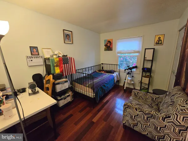 a living room with furniture a flat screen tv and a window