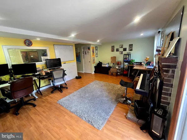 a view of a livingroom with workspace and a couch