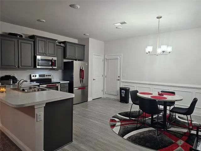 a view of a dining room with furniture and wooden floor