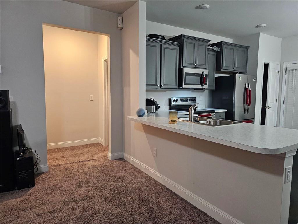 2153 Red Oak Circle Union City, GA 30291 - Photo 22 of 34 a kitchen with stainless steel appliances a sink stove and refrigerator