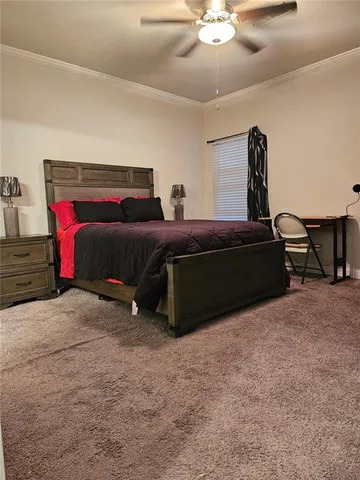 a spacious bedroom with a bed and a chandelier