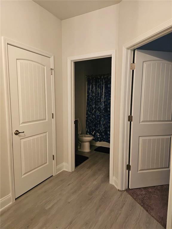2153 Red Oak Circle Union City, GA 30291 - Photo 5 of 34 an empty room with wooden floor cabinet and a bathroom