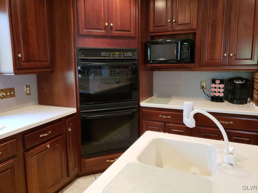 363 Halletts Road Mount Bethel, PA 18343 - Photo 9 of 21 a kitchen with wooden cabinets and a stove top oven