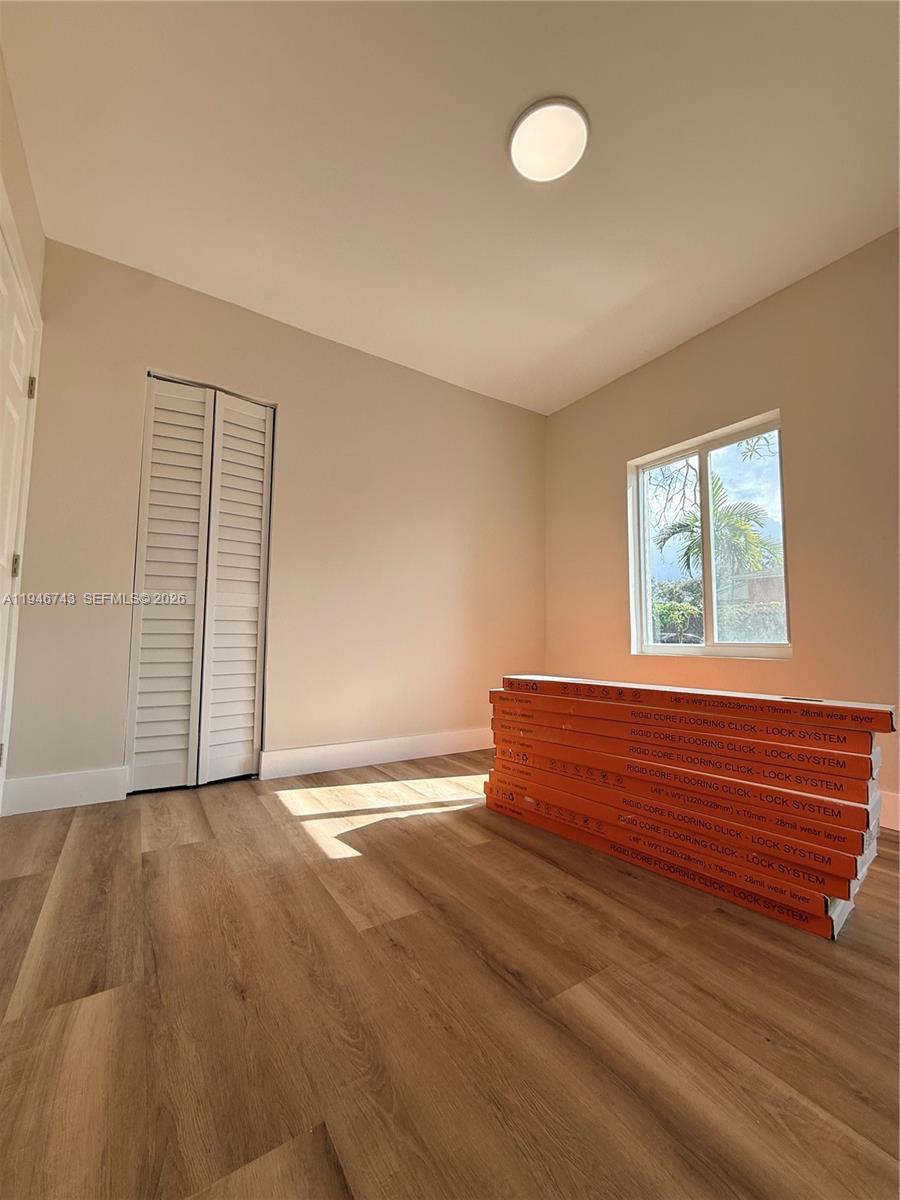 14600 Harrison Street Miami, FL 33176 - Photo 12 of 32 an empty room with wooden floor and windows