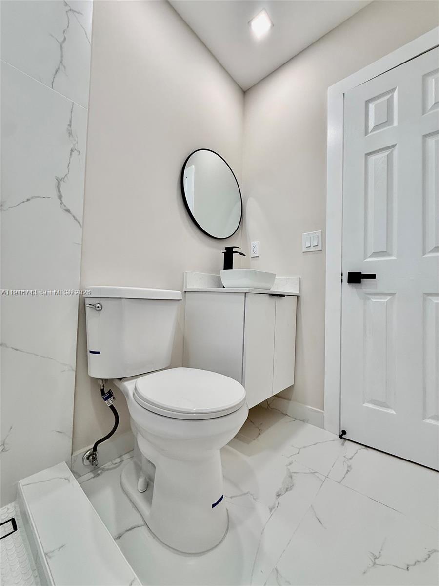 14600 Harrison Street Miami, FL 33176 - Photo 13 of 32 a bathroom with a toilet a sink and a mirror