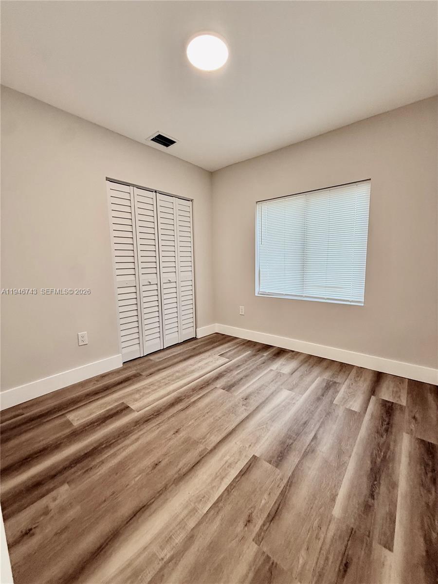 14600 Harrison Street Miami, FL 33176 - Photo 16 of 32 an empty room with wooden floor and windows