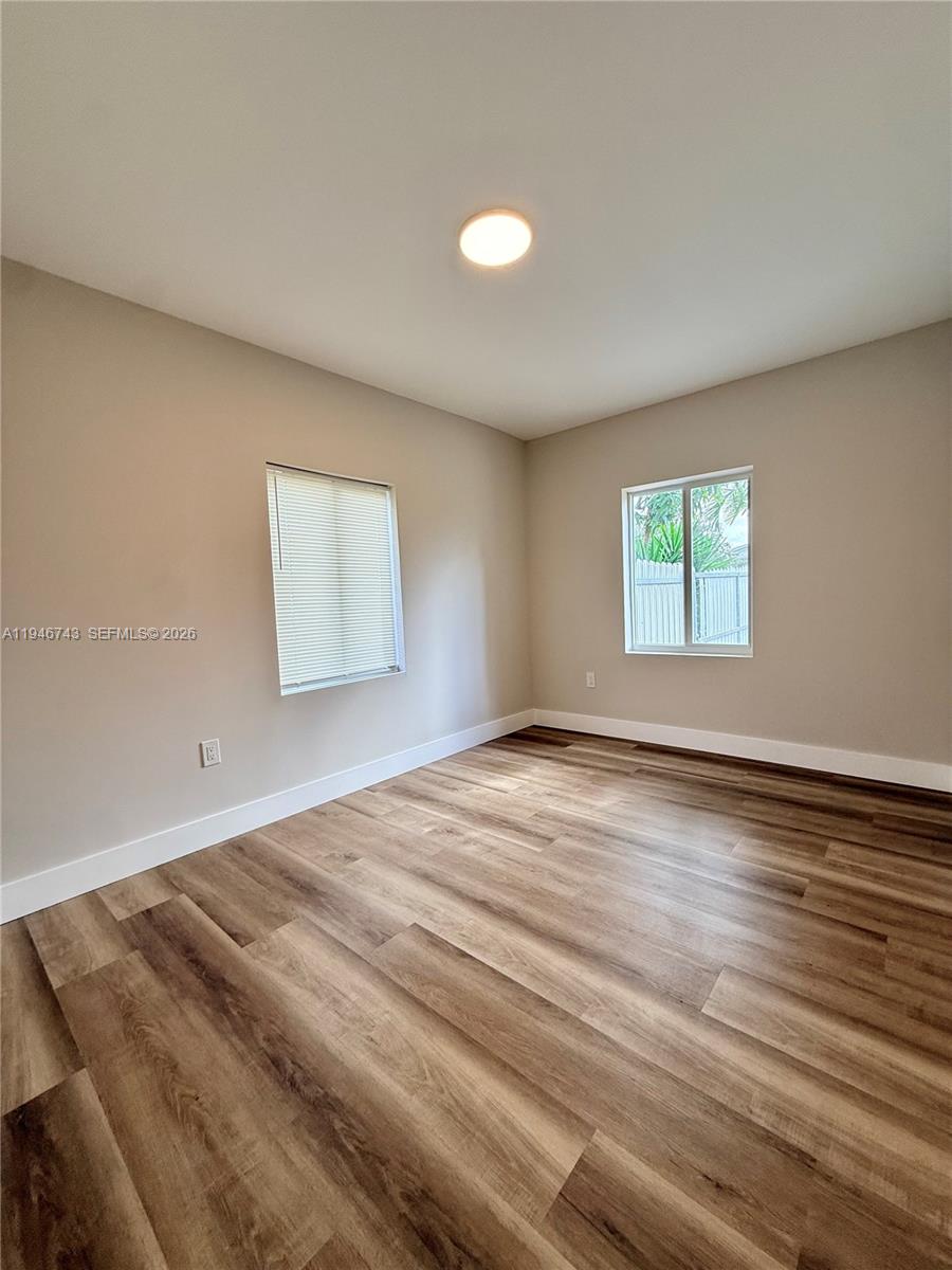 14600 Harrison Street Miami, FL 33176 - Photo 17 of 32 an empty room with wooden floor and windows