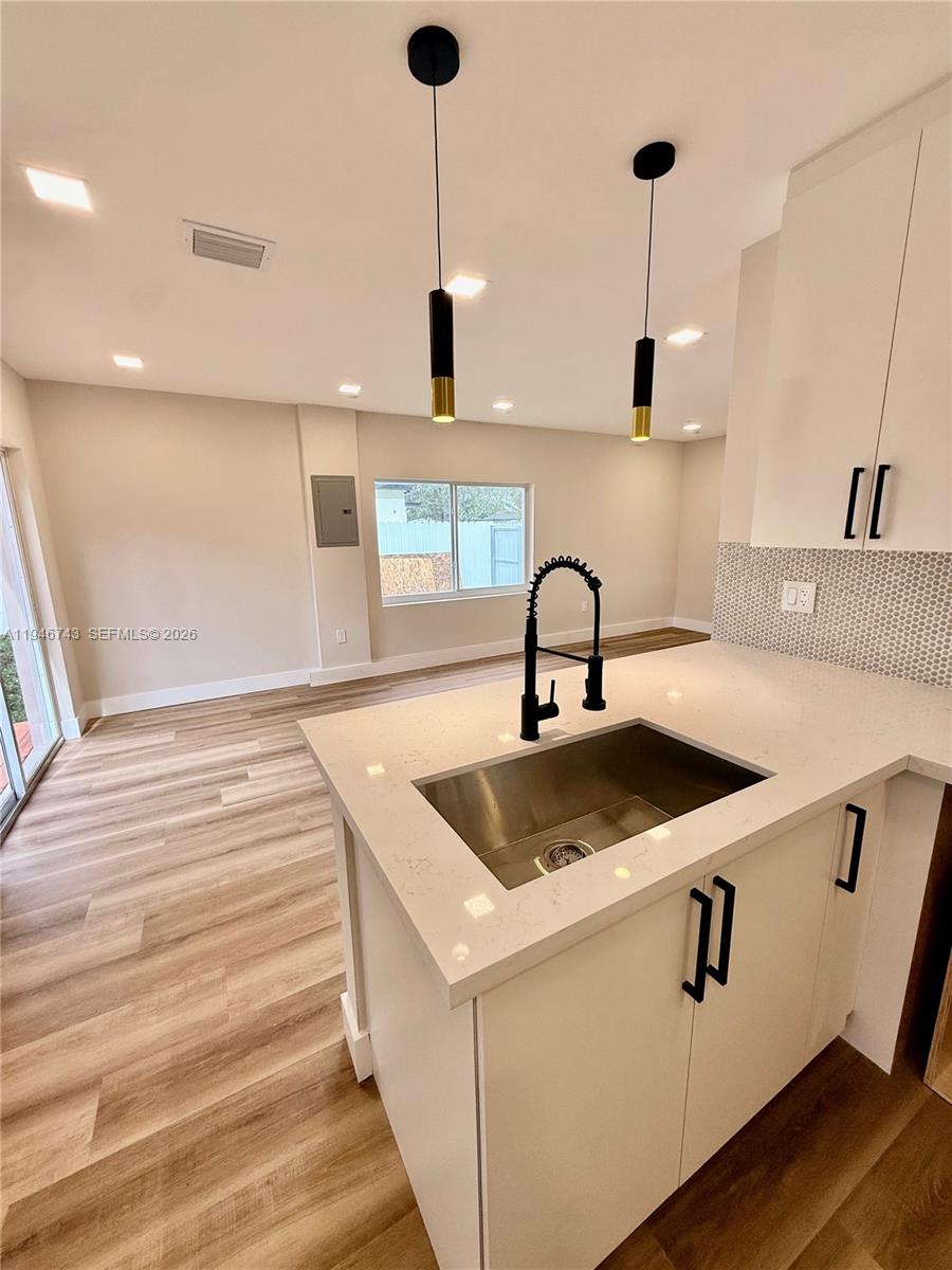 14600 Harrison Street Miami, FL 33176 - Photo 20 of 32 a kitchen with a sink and chandelier