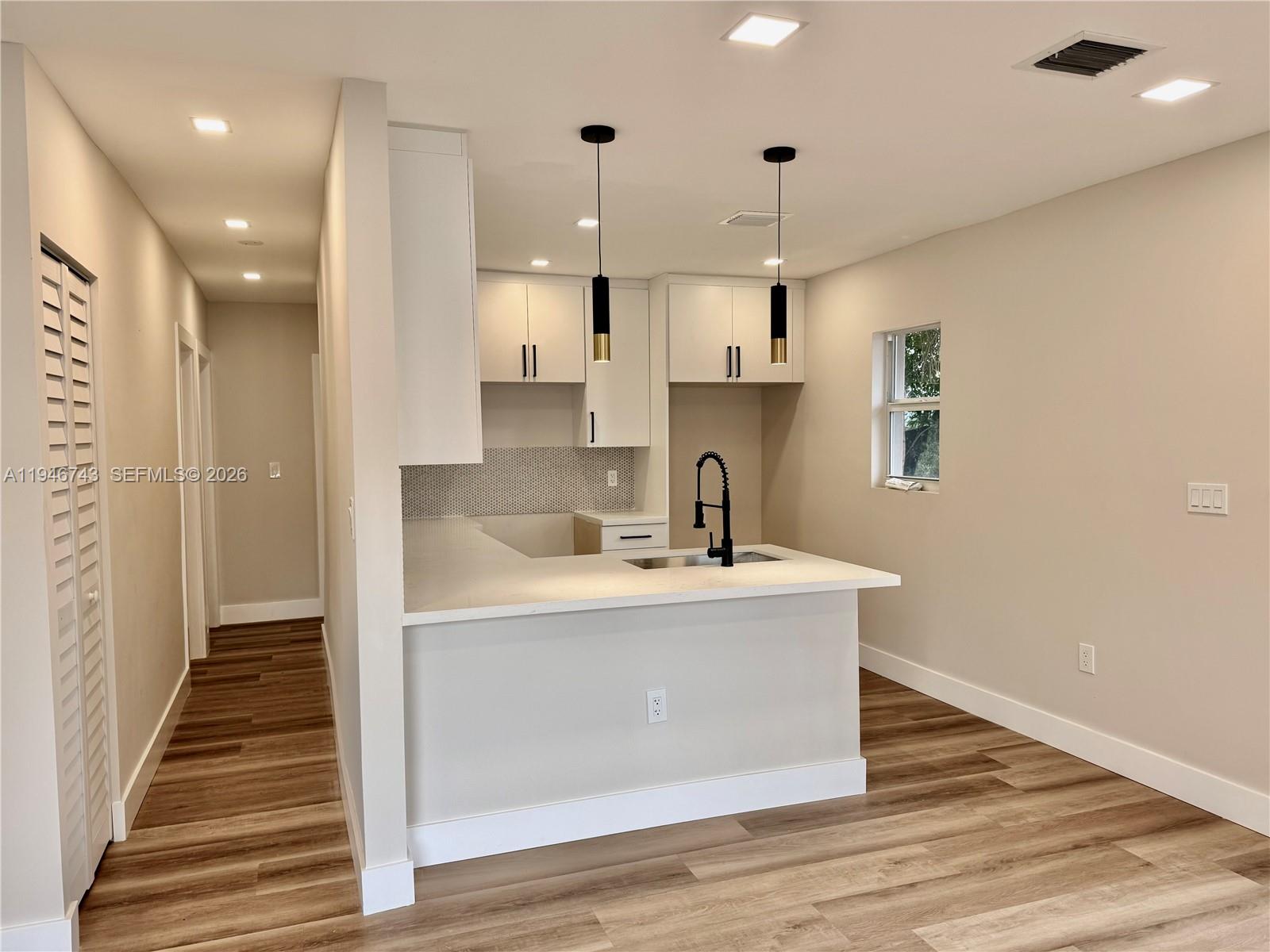 14600 Harrison Street Miami, FL 33176 - Photo 21 of 32 a very nice looking kitchen with a large window wooden floor and stainless steel appliances