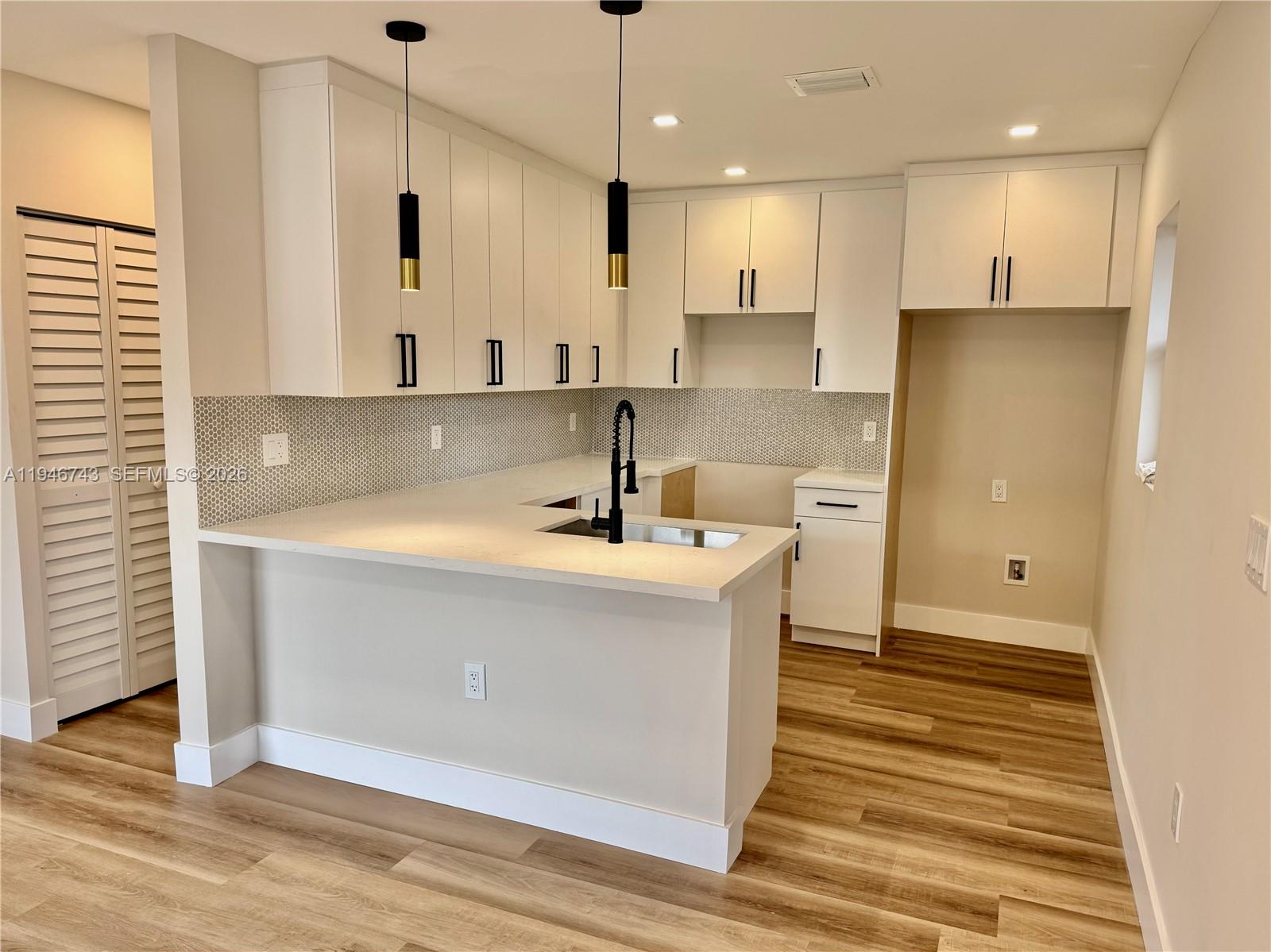 14600 Harrison Street Miami, FL 33176 - Photo 24 of 32 a kitchen with kitchen island a sink stainless steel appliances and cabinets