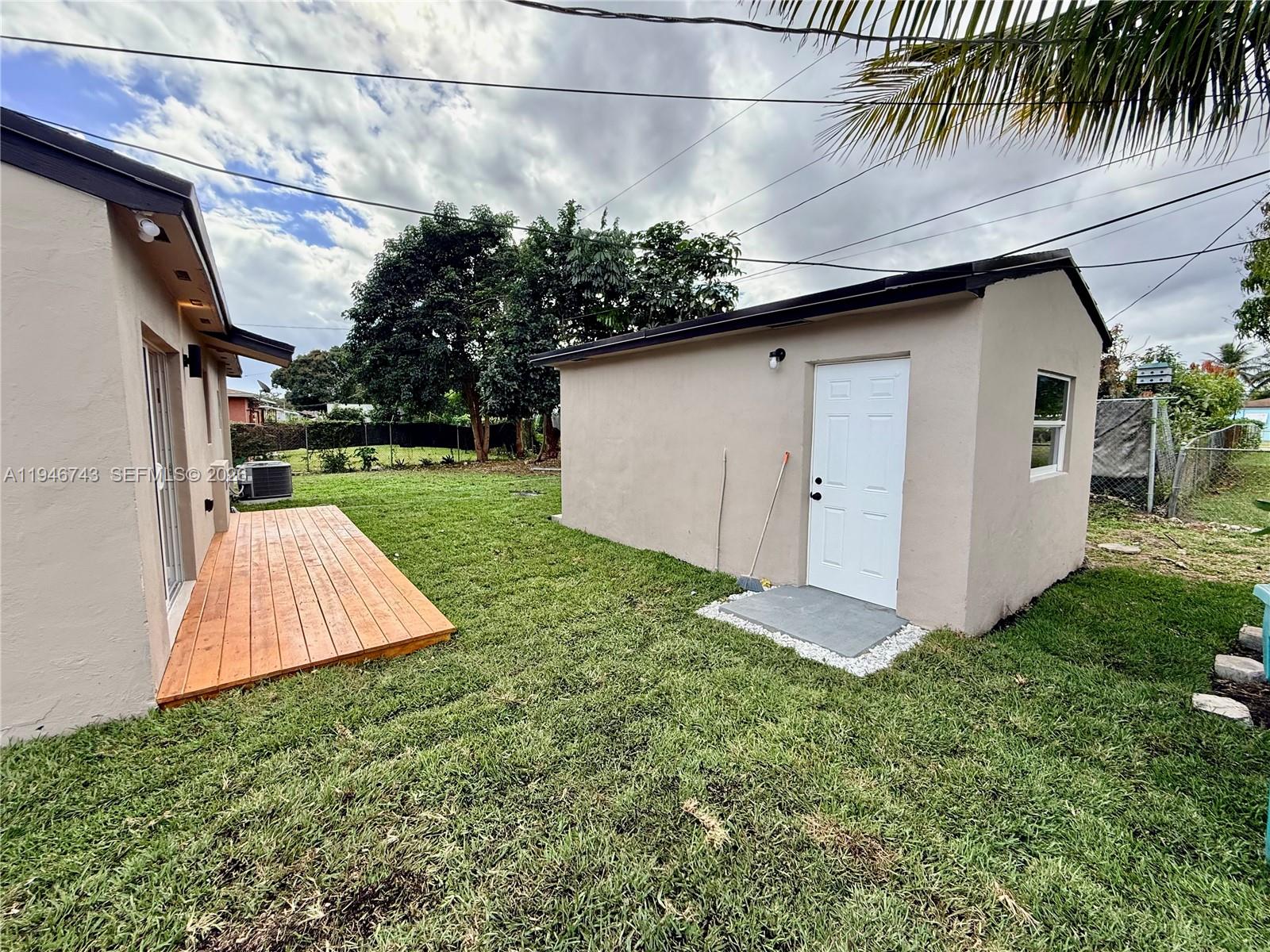 14600 Harrison Street Miami, FL 33176 - Photo 6 of 32 a view of a backyard with potted plants and large tree