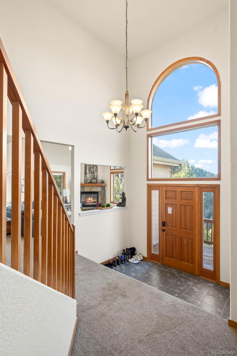 900 Sawmill Creek Road Evergreen, CO 80439 - Photo 16 of 50 a view of a livingroom with wooden floor and stairs