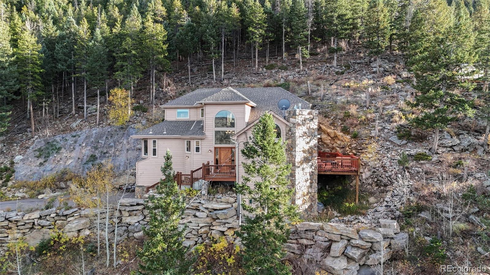900 Sawmill Creek Road Evergreen, CO 80439 - Photo 2 of 50 a aerial view of a house with a yard