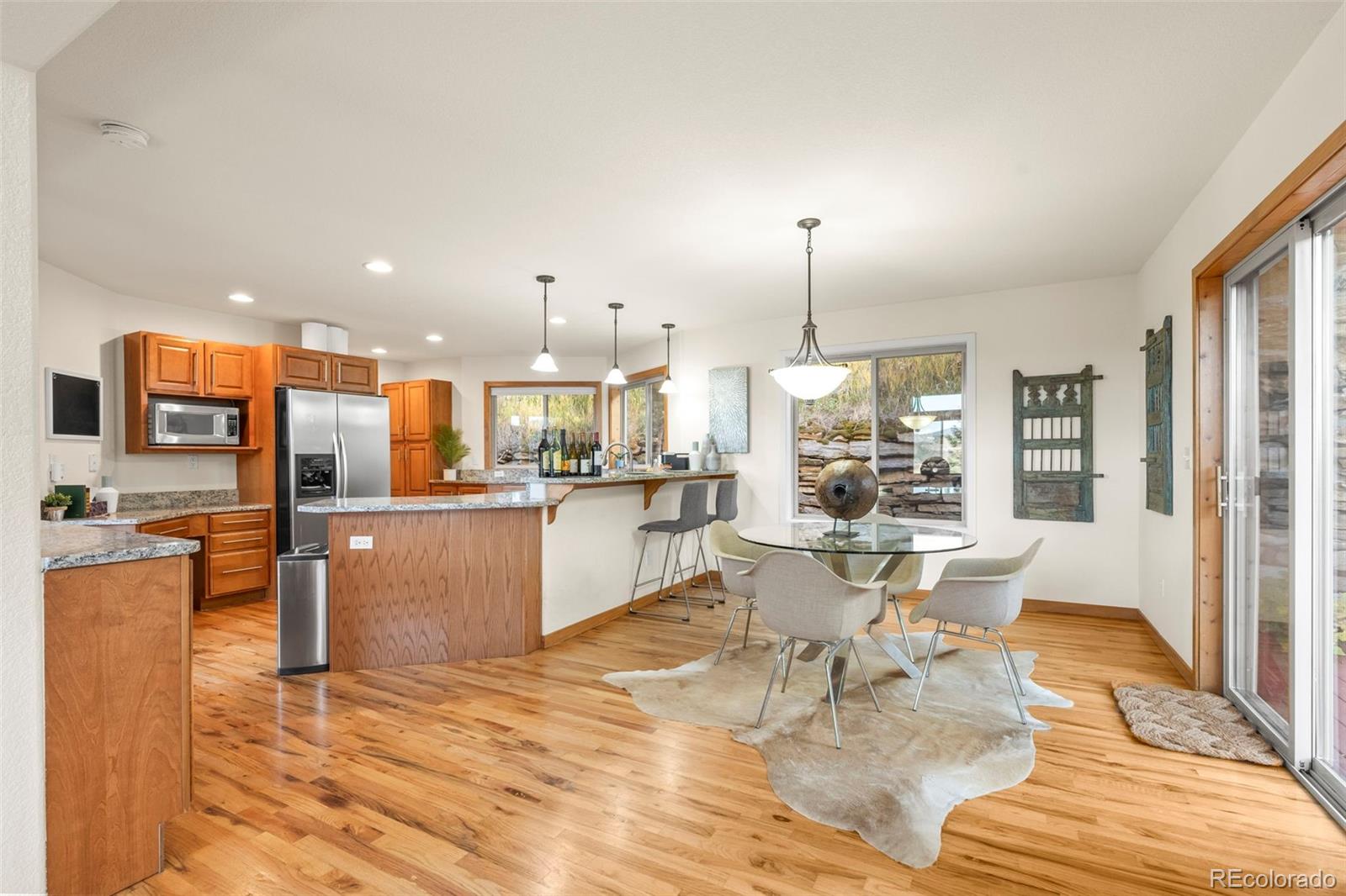900 Sawmill Creek Road Evergreen, CO 80439 - Photo 21 of 50 a living room with stainless steel appliances kitchen island granite countertop furniture and a wooden floor
