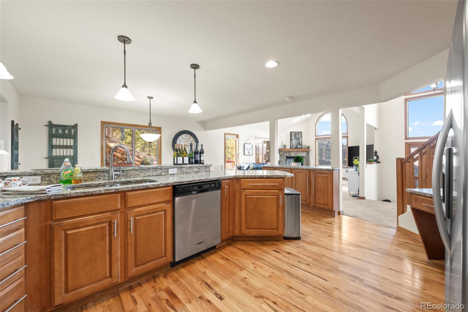900 Sawmill Creek Road Evergreen, CO 80439 - Photo 28 of 50 a kitchen with stainless steel appliances granite countertop a sink a stove and a wooden floors