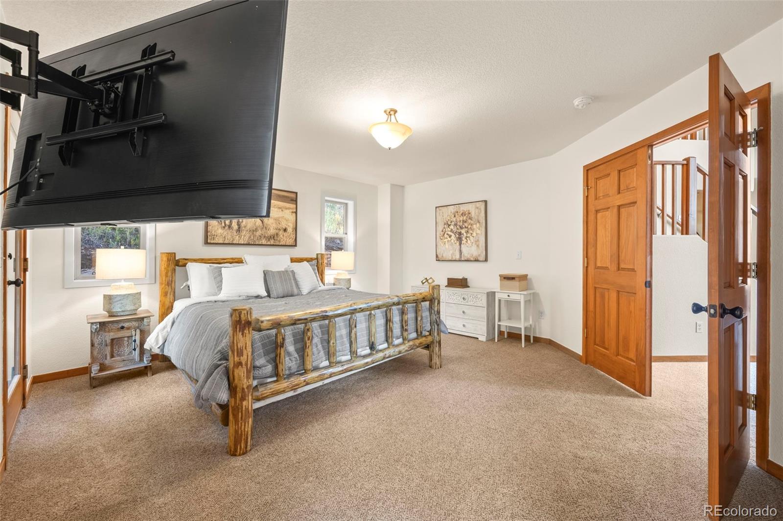 900 Sawmill Creek Road Evergreen, CO 80439 - Photo 32 of 50 a bedroom with a bed closet and a window