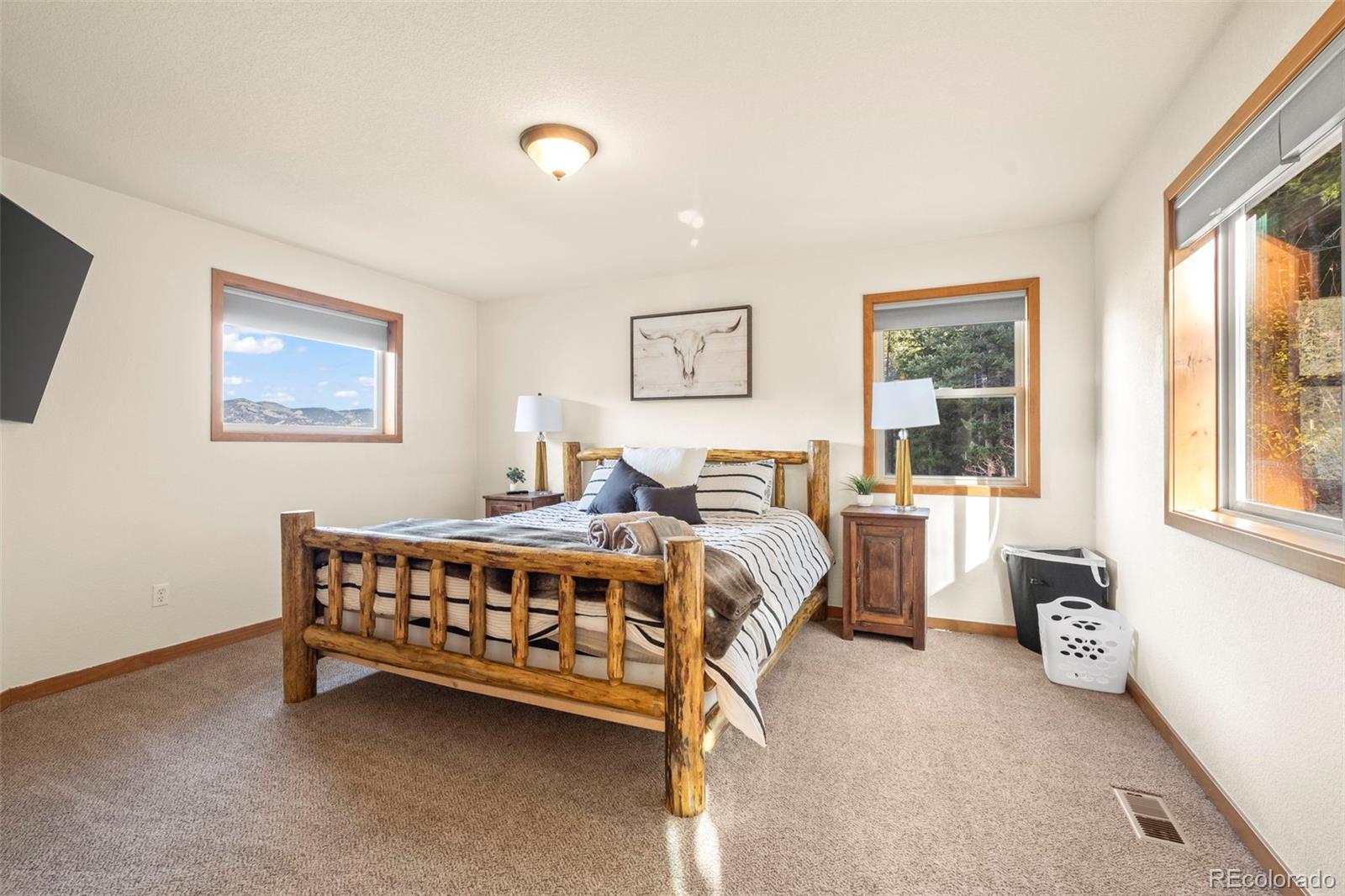 900 Sawmill Creek Road Evergreen, CO 80439 - Photo 36 of 50 a bed room with a bed and a chair