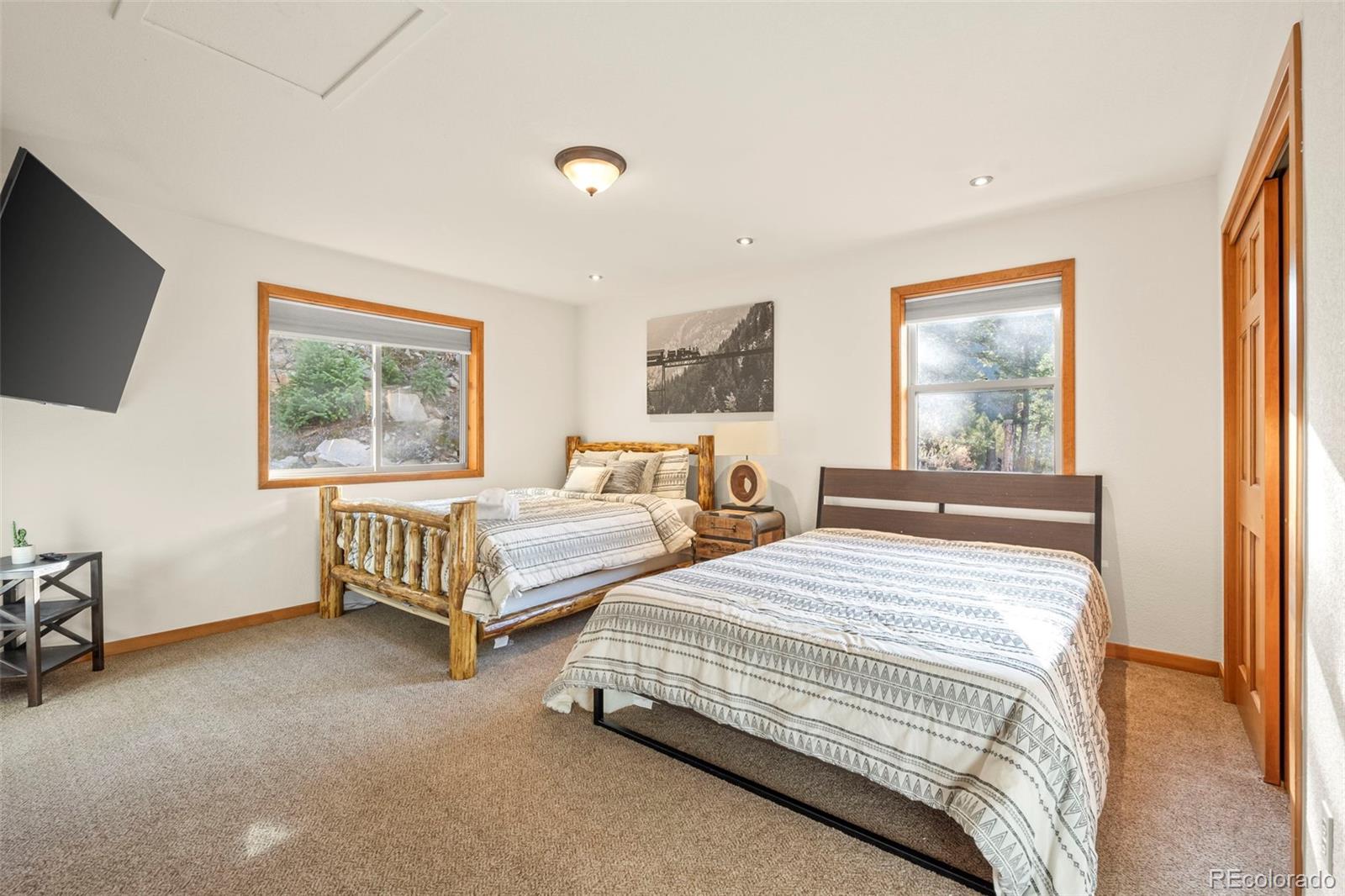 900 Sawmill Creek Road Evergreen, CO 80439 - Photo 37 of 50 a bedroom with two beds and a window