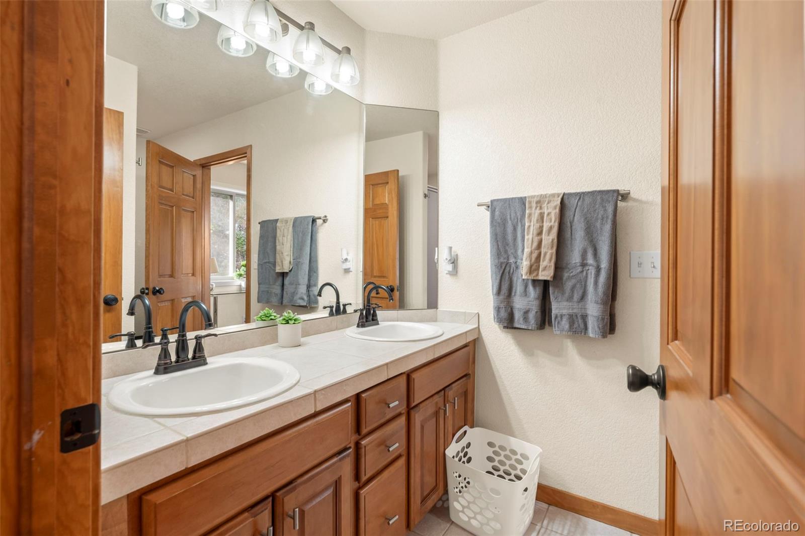 900 Sawmill Creek Road Evergreen, CO 80439 - Photo 39 of 50 a bathroom with a sink double vanity and a mirror