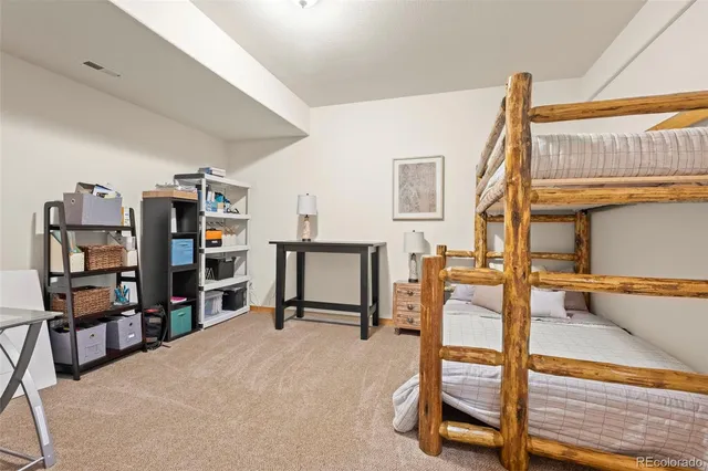a view of a bedroom with workspace and window