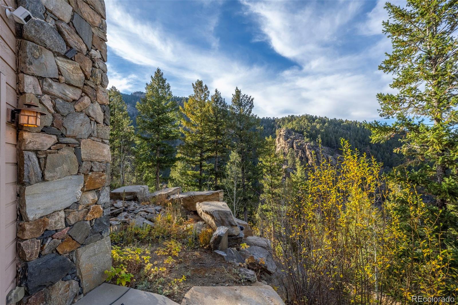 900 Sawmill Creek Road Evergreen, CO 80439 - Photo 7 of 50 a view of a city with lush green forest