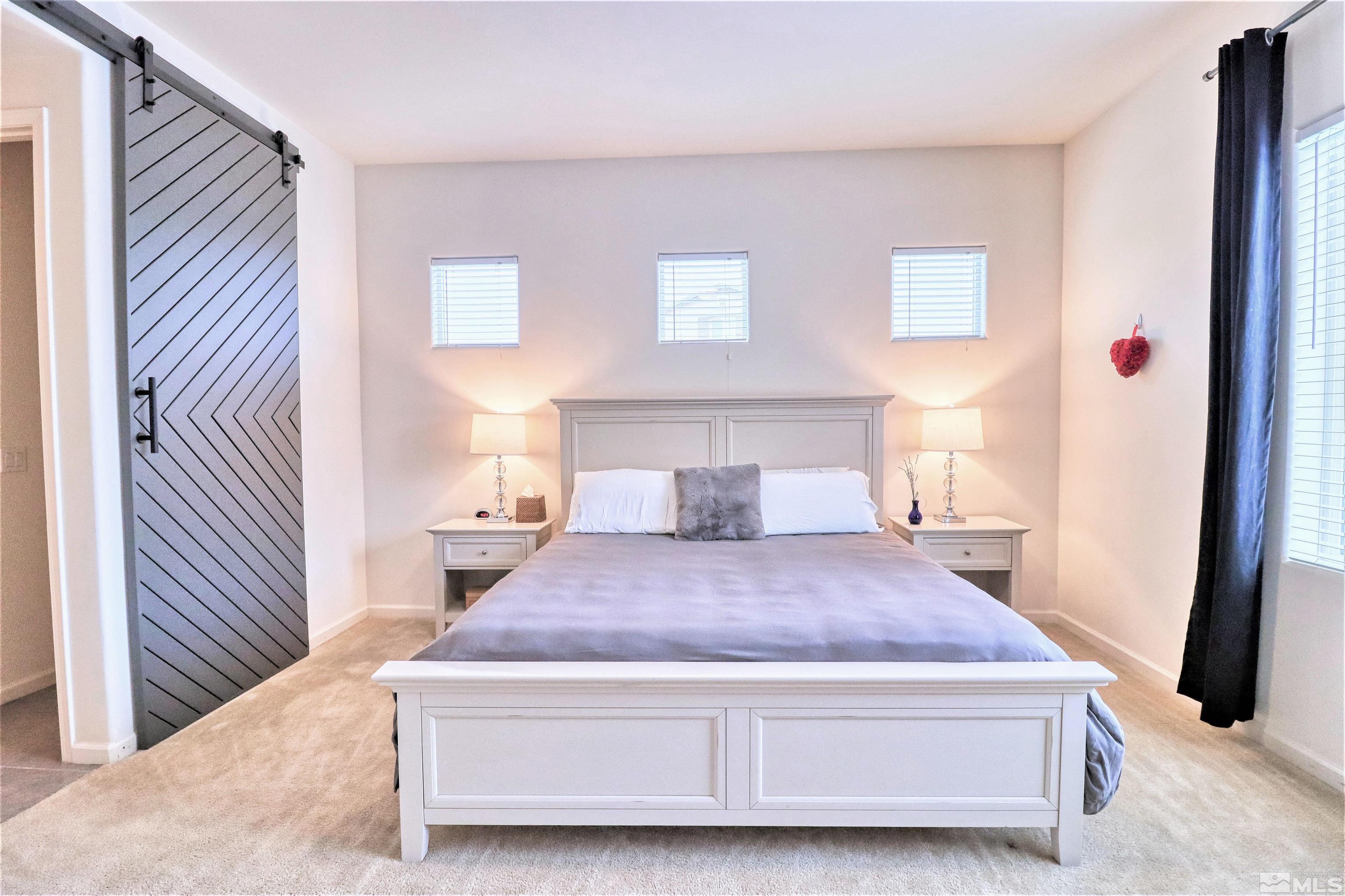 2790 Bonfire Lane Reno, NV 89521 - Photo 16 of 37 a spacious bedroom with a bed and a window