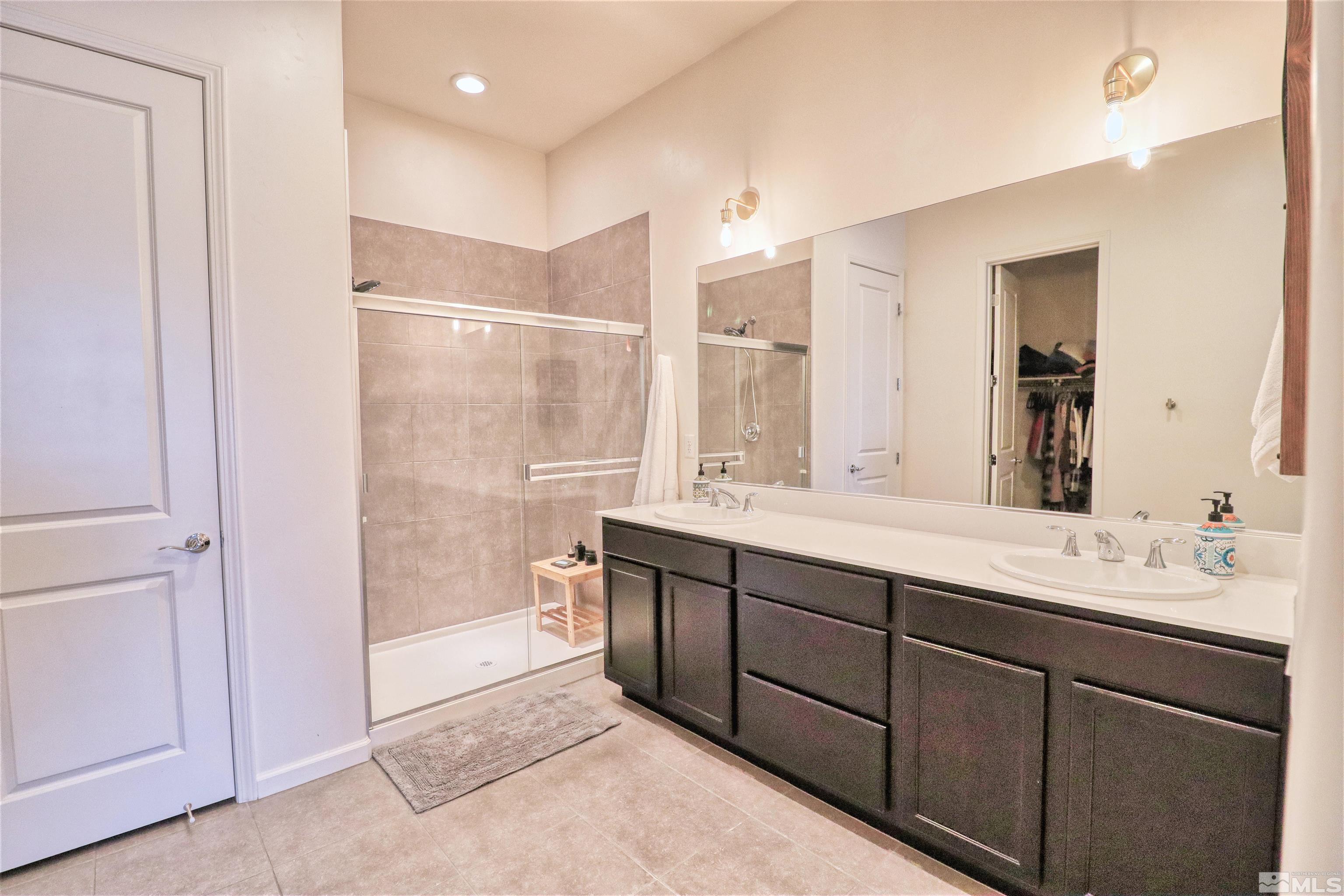 2790 Bonfire Lane Reno, NV 89521 - Photo 18 of 37 a spacious bathroom with a shower sink and mirror