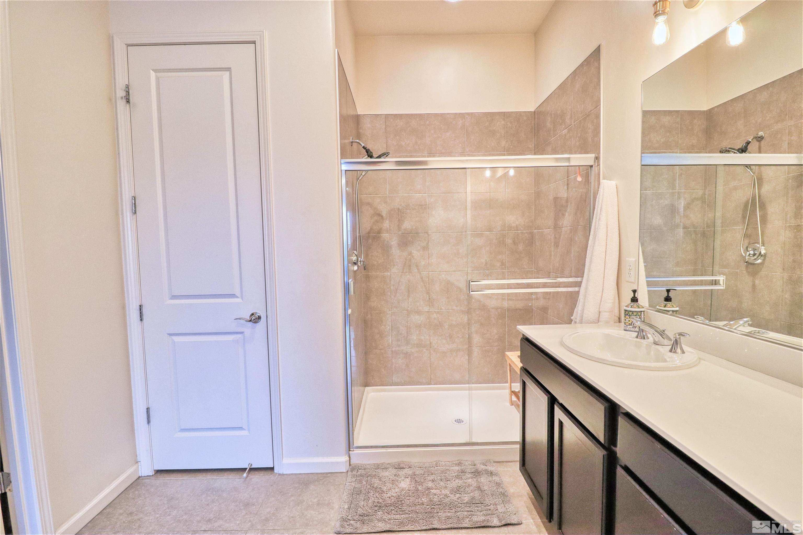 2790 Bonfire Lane Reno, NV 89521 - Photo 19 of 37 a bathroom with a sink a mirror and a shower